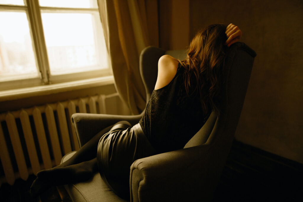 a woman who's suffering and unmotivated sitting on a chair